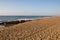 Extensive Stretch of Beach Sand with Rocks