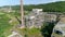 Exterior abandoned factory hall in Loznica Serbia Chimneys aerial drone shot