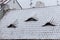 Exterior of apartments with gable roofs covered with snow in winter. Tiled roof in the snow. Czech Republic