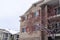 Exterior of apartments with snowy roofs under overcast sky during winter season