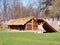 exterior of the archeopark, log construction with straw roofing, ancient Celtic buildings