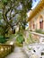 Exterior architectural details of a mansion lined with flowers and plants