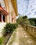 Exterior architectural details of a mansion lined with flowers and plants