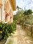 Exterior architectural details of a mansion lined with flowers and plants