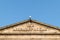 Exterior of The Assembly Rooms building showing sign with blue sky behind