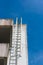 Exterior of building with the fire escape.blue sky background