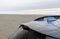 Exterior details of blue hatchback at sand beach in dusk light