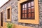 Exterior details of a stone building with orange framed windows Madeira, Portugal,Europe