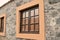 Exterior details of a stone building with orange framed windows Madeira, Portugal,Europe