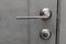 Exterior door handle. Gray metal doorknob
