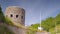 The exterior facade of a round tower made of stone