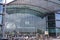 Exterior of front entrance of Berlin Central Train Station in summer with crowd of people