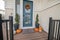 Exterior of a house with blue front door and vinyl half wall siding.