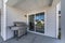 Exterior of a house with a sliding glass door and vinyl sidings