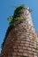 exterior of a large old derelict and unused fireplace overgrown with ivy