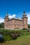 The exterior of Marsvinsholm castle against blue skies in southern Sweden