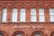 Exterior of Masonic Hall brick building showing sign in gold