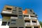 Exterior of a modern black apartment buildings on a blue sky background. No people.