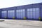 Exterior of modern distribution center warehouse grey door facade