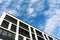 Exterior of new apartment buildings on a blue cloudy sky backgr