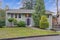 Exterior of a nicely renovated home with green siding and white trim