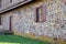 Exterior of old stone colonial American home with window shutters