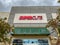 The exterior sign above a Supercuts hair salon storefront in Orlando, Florida