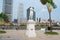 Exterior of the Sir Thomas Stamford Bingley Raffles statue with modern buildings at the background in Singapore, Singapore.