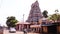 Exterior Traditional Hindu temple India, Passing bus and car