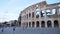 Exterior view of blurred Roman Coloseum with tourists walking in Rome Italy