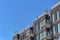 Exterior view of a luxury modern apartment with balconies against blue sky