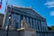 Exterior view of the main facade of the French National Assembly with netting covering the restauration scaffolding