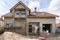 Exterior view of new house under construction and painting. External plaster of the walls of a two-story house.