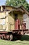 Exterior view of an old obsolete yellow and red 19th Century railroad train caboose