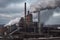 exterior view of steel manufacturing plant, with smoke rising from the chimney and sparks flying from the furnace