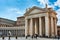 Exterior view of the Tuscan Colonnades with sculptures and people walking at Saint Peter`s Square in the Vatican City