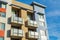 Exterior view of typical new multifamily mid-rise residential building with balconies. The buildings usually rental apartments,