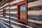 Exterior wall of colonial log cabin landscape reflected in window