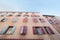 Exterior wall with many windows and shutters, building and architecture Narbonne, France.