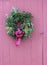 Exterior wall of rustic red barn with pretty wreath on door