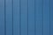 Exterior wall texture background with bright blue painted vertical wood siding