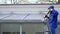 Exterior washing and building cleaning glass roof with high pressure water jet.