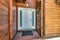 Exterior of a white front door of a house with wood siding