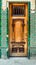 Exterior wooden front door with glass and multi-colored carved o