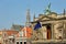 The external facade of Teylers Museum, located along Spaarne river, with the clock tower of St Bavokerk Church in the background