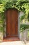 External wooden close door border with a green hedge