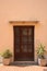 External wooden close door and two jars of plants