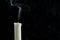 An extinct candle with smoke on a black background. copy space for your text