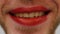 Extra close up of man`s lips with red lipstick. Man with bearded face and red lipstick on lips. Travesty makeup concept