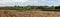 Extra large panoramic view of harvested farmland with cornfields an potato fields